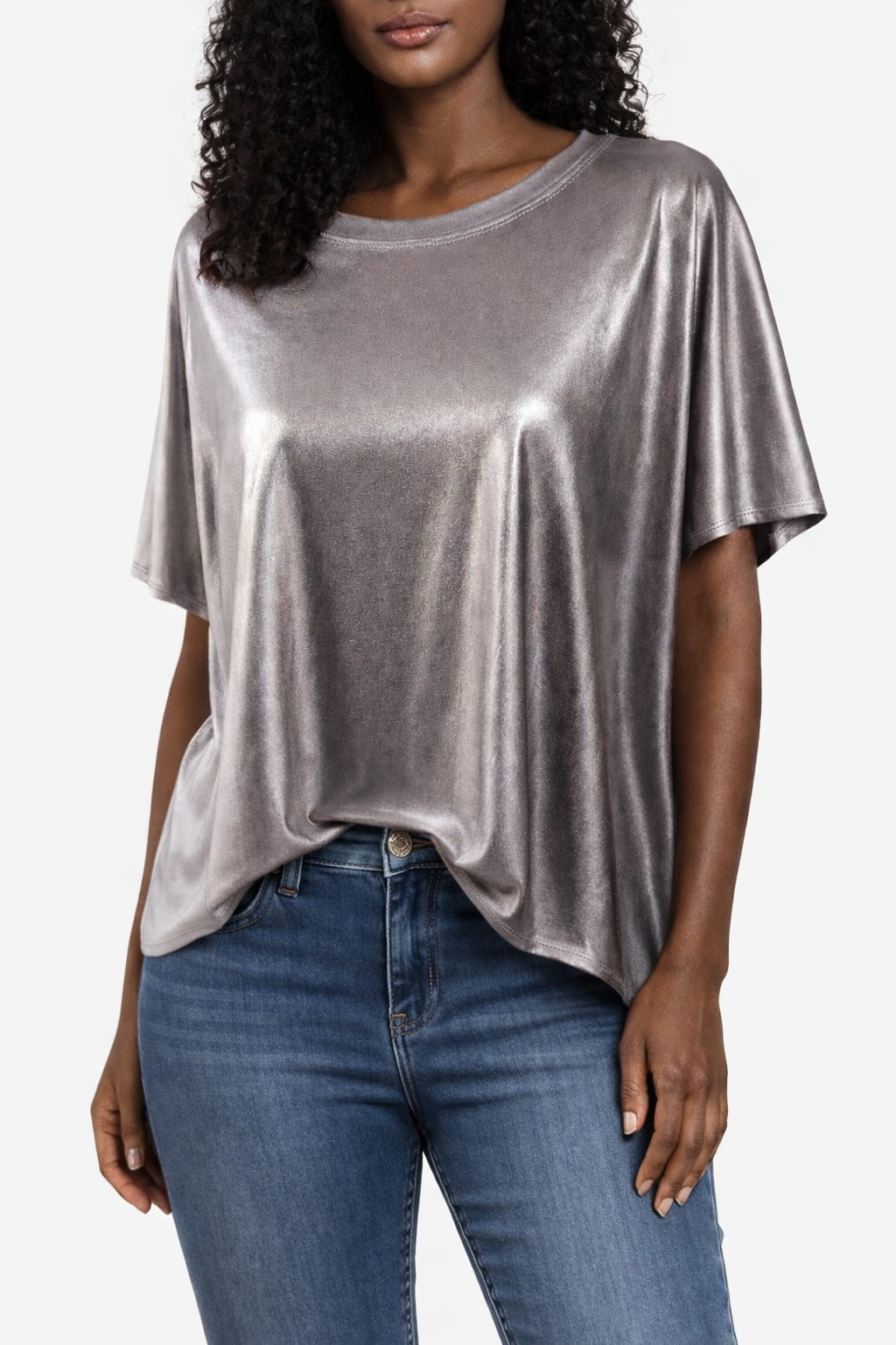 Woman wearing a silver metallic jersey top styled with denim.